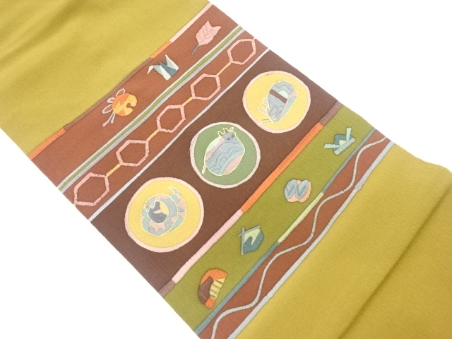 縮緬地金彩横段に干支模様名古屋帯